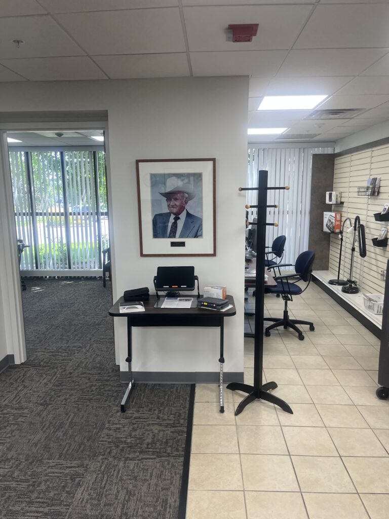 Image shows a lobby at the Curtis Strong Center with a photo of Curtis Strong hanging above an electronic magnifier.
